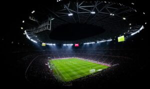 Aerial view of a night football match in Budapest. Illuminated stadium full of fans adds dramatic — mecz Polska Rumunia