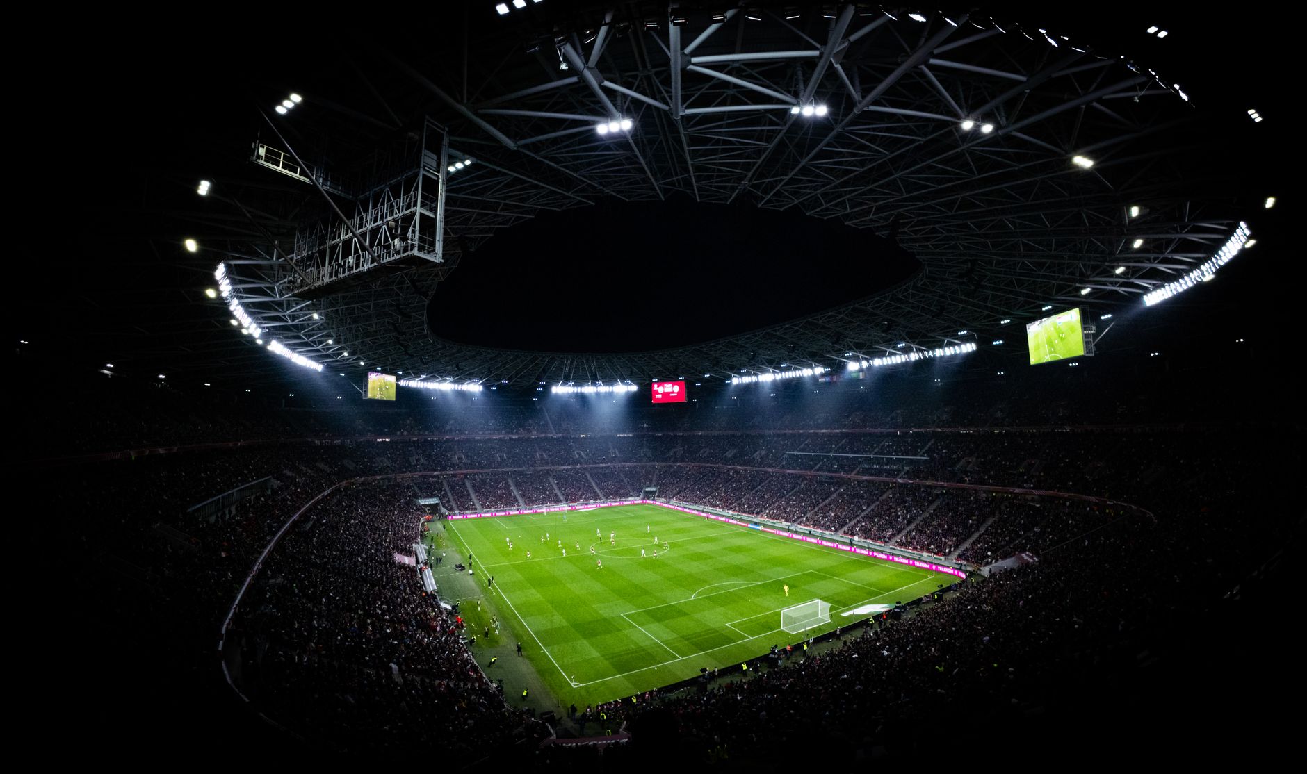 Aerial view of a night football match in Budapest. Illuminated stadium full of fans adds dramatic — mecz Polska Rumunia
