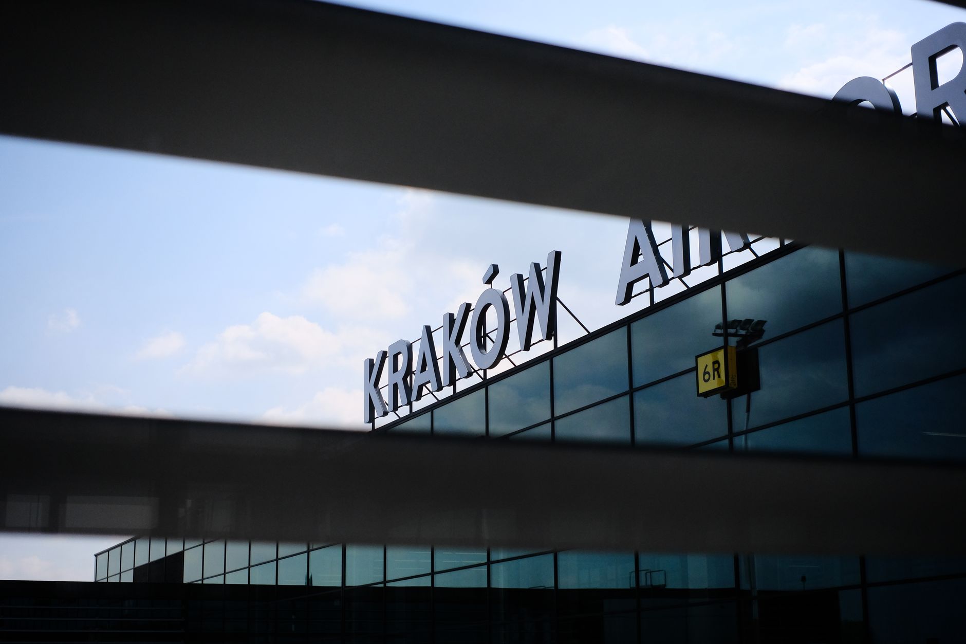 A modern architectural detail of the facade of Kraków Airport with reflective glass panels. — wybory w Krakowie