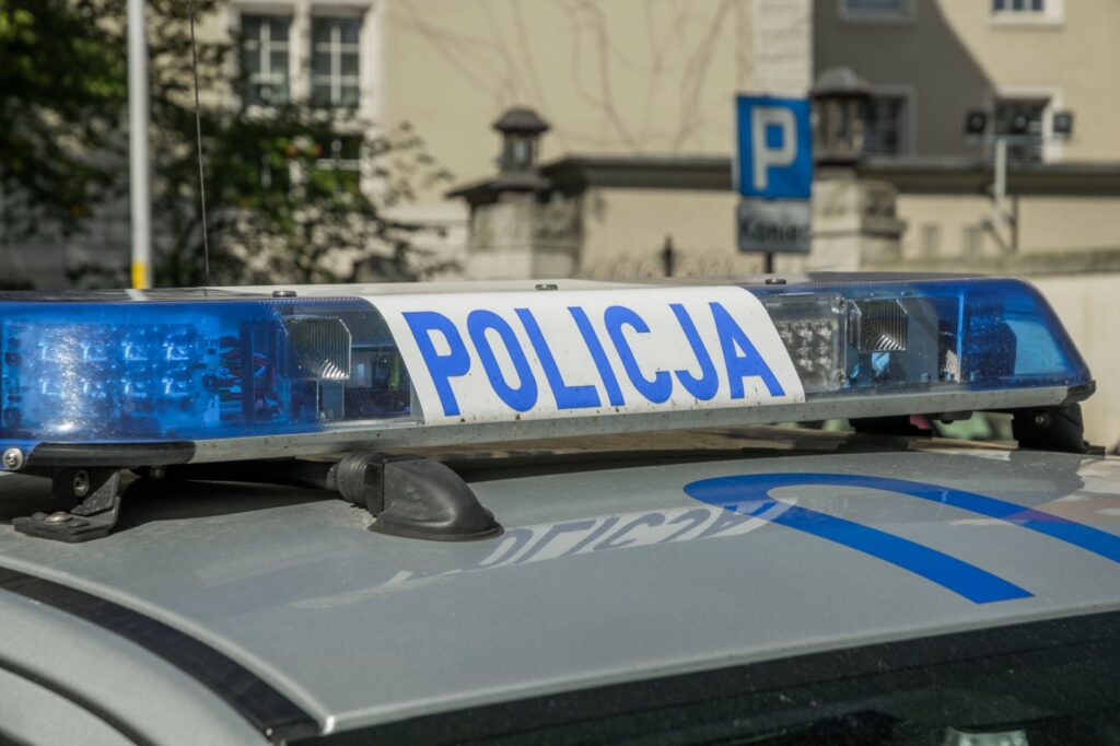 A close-up image showing the light bar of a Polish police car with the word 'Policja'. — bezpieczeństwo szkoły w Sierpcu