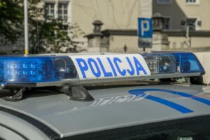 A close-up image showing the light bar of a Polish police car with the word 'Policja'. — bezpieczeństwo szkoły w Sierpcu