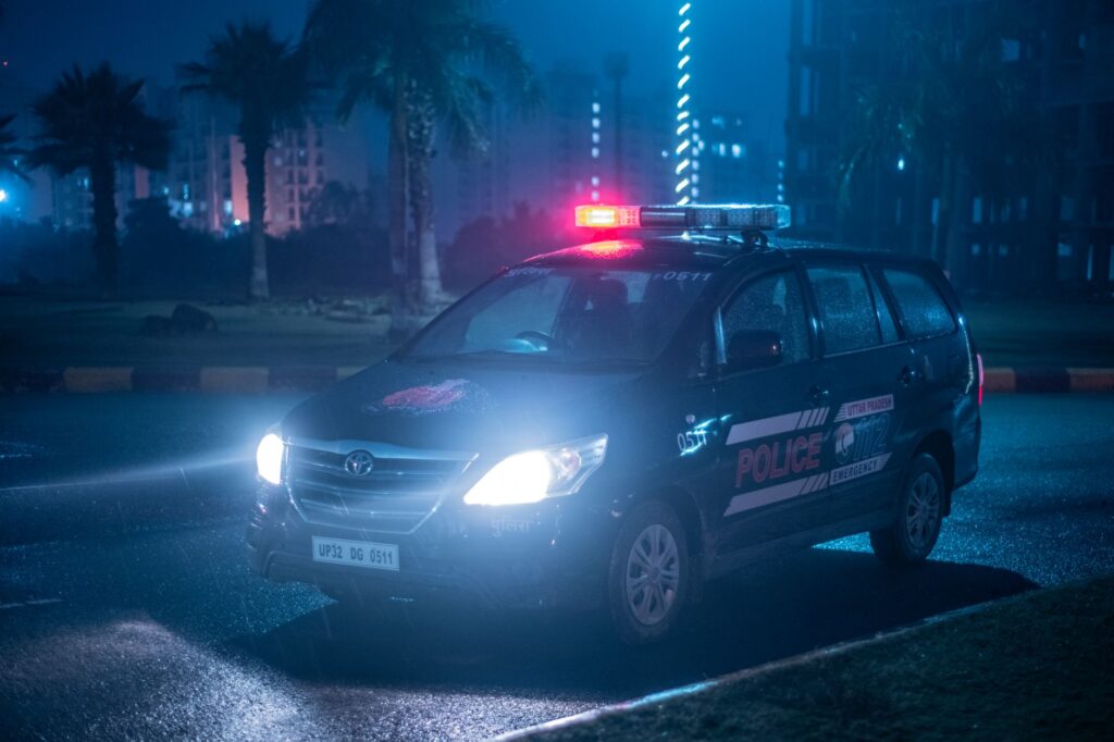 A Toyota police car patrols under city lights at night in Uttar Pradesh, India. — wypadek na drodze ekspresowej S8