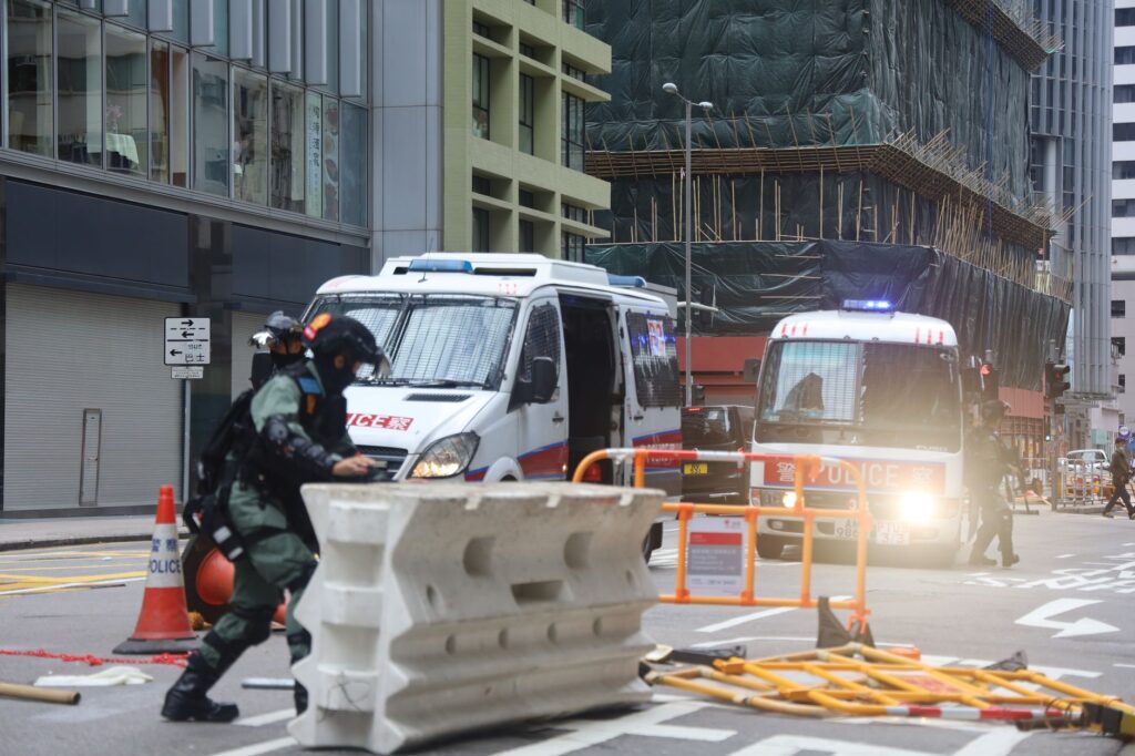 Military police truck equipped with emergency lights moving on fenced road in city during protests in — akcja saperów w Szczecinie