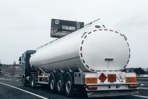 Rear view of a large tanker truck transporting fuel on a highway, emphasizing logistics and — import rosyjskiego oleju napędowego