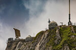 Swiss radar system perched on a rugged mountainside, showcasing technical and natural contrast. — obrona powietrzna Ukrainy