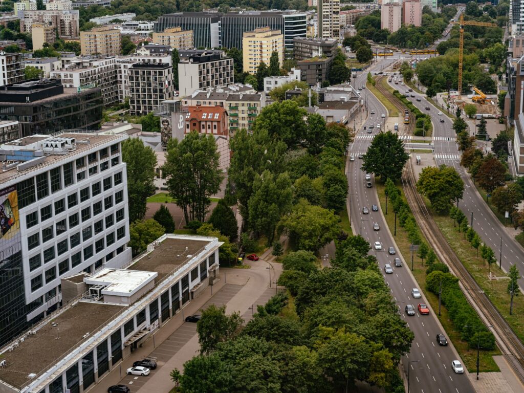 Aerial view of Warsaw city showcasing modern architecture, streets, and greenery. — list żelazny dla Marcina Romanowskiego
